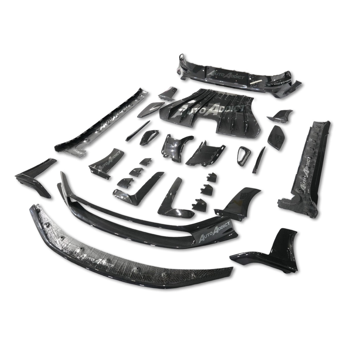 Collection of black car body panels and components on a white background