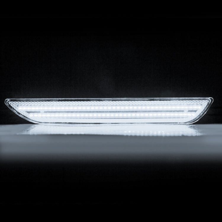 Car LED daytime running light on a reflective surface with a black background