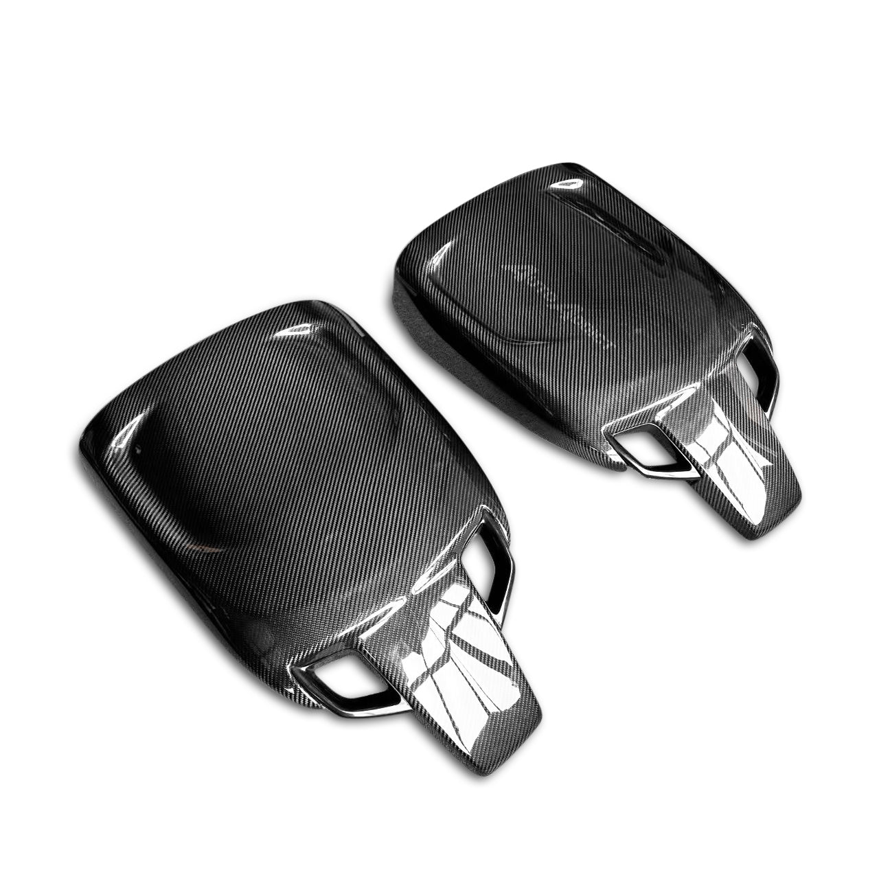 Two carbon fiber key covers on a white background