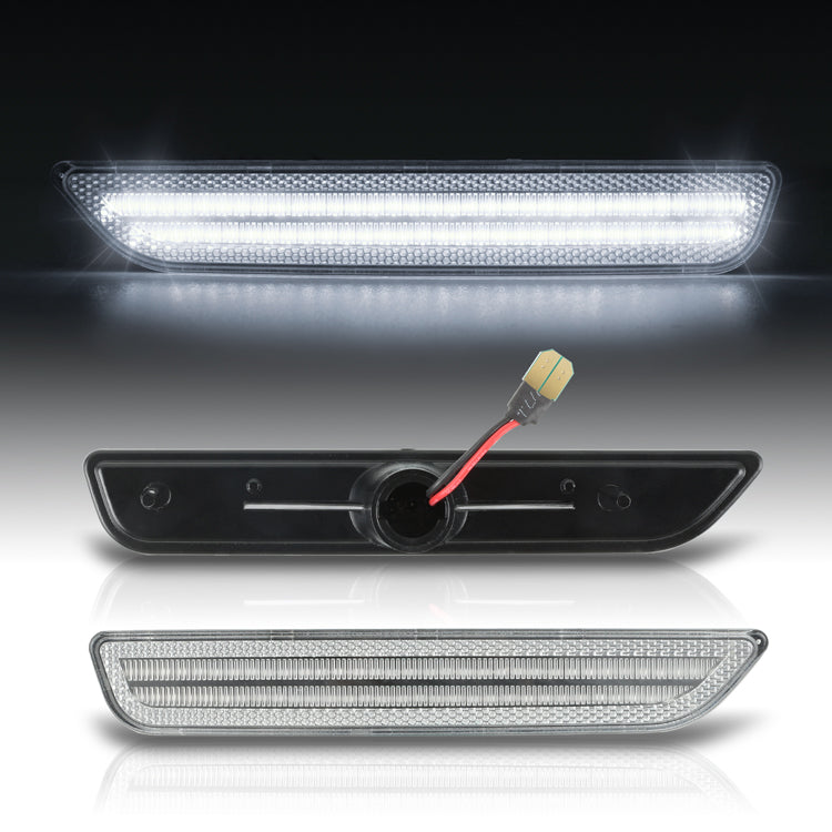Three car LED daytime running lights on a reflective surface with a dark background.