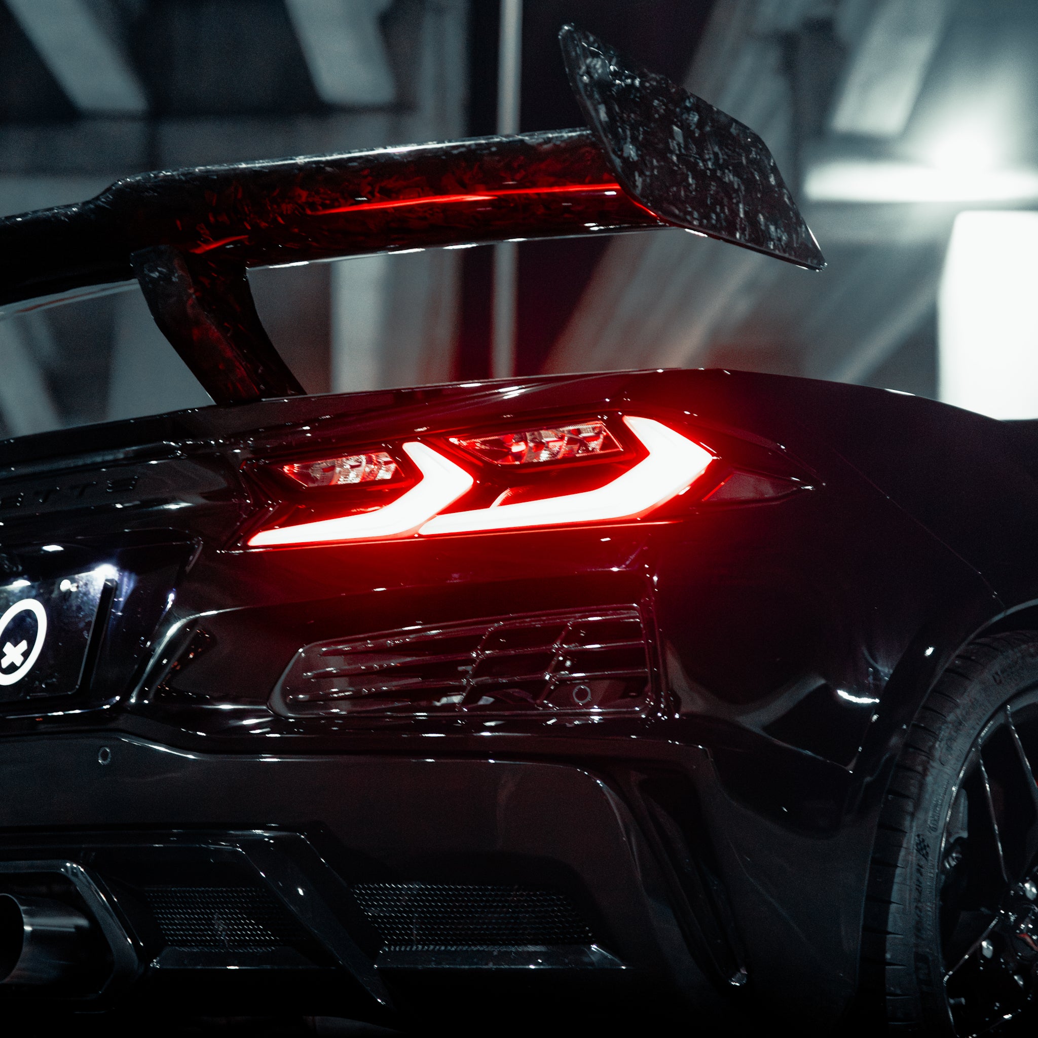 Installed Corvette C8 forged carbon aero kit aggressive track stance front three quarter view
