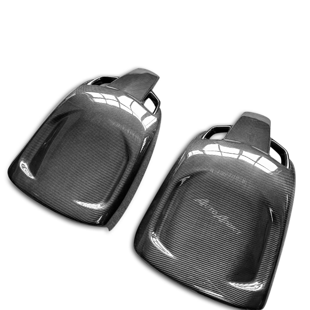 Two carbon fiber car parts on a white background
