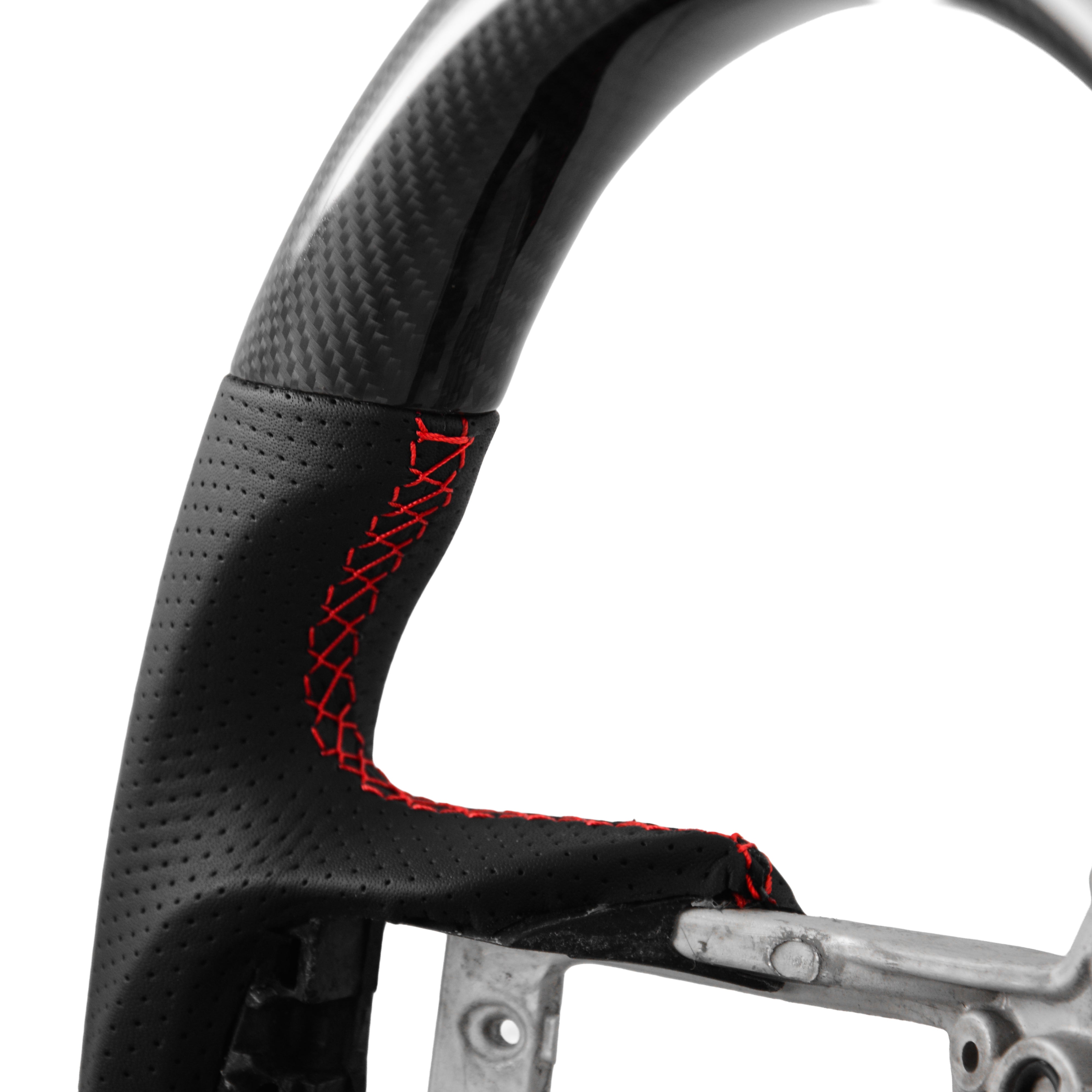 Real carbon fiber heated steering wheel close up showing high-gloss carbon weave and premium craftsmanship